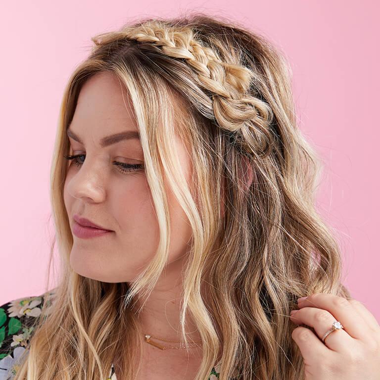 A close-up image of a model with a crown braid hairstyle
