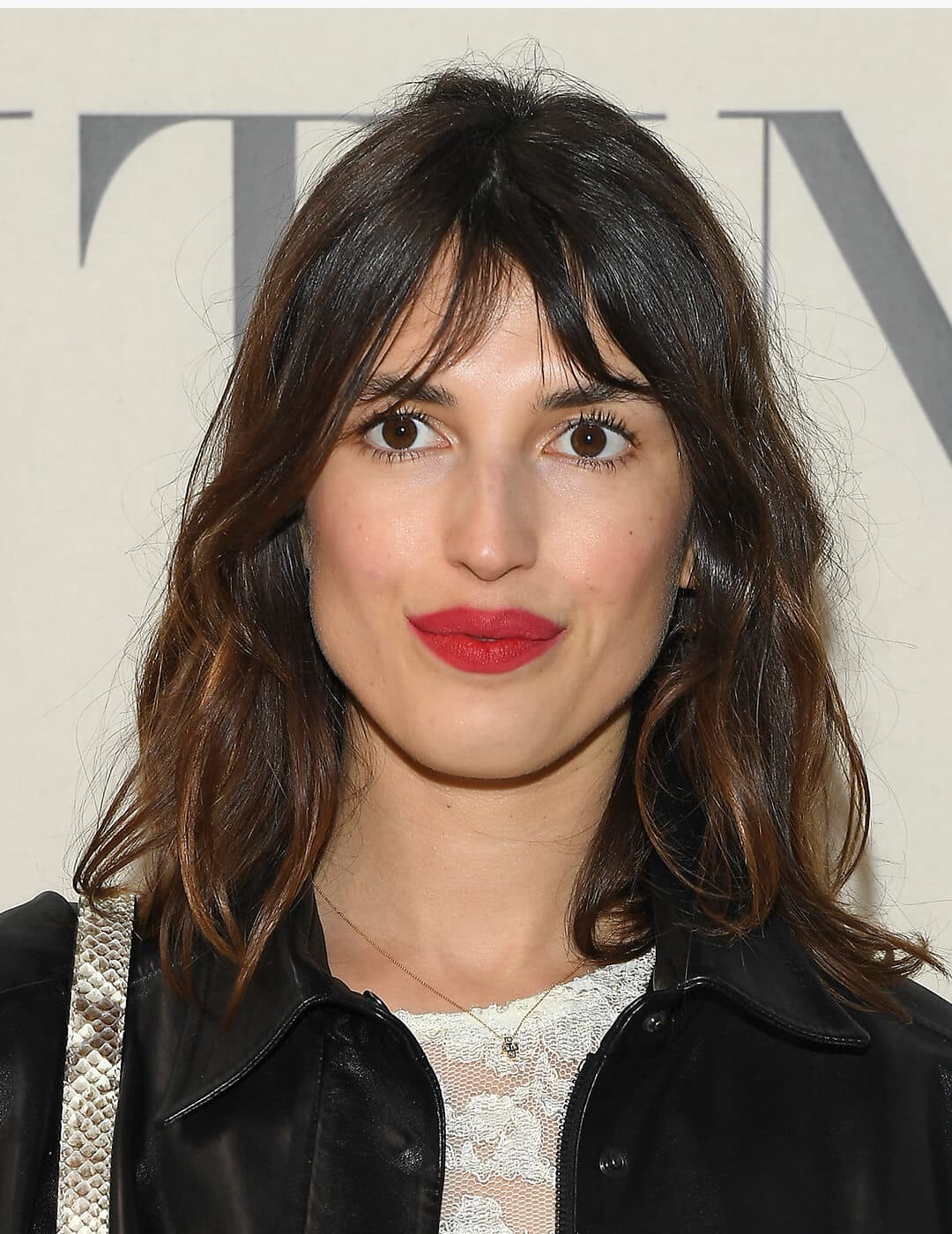 Jeanne Damas with a natural makeup look paired with red lips at the red carpet