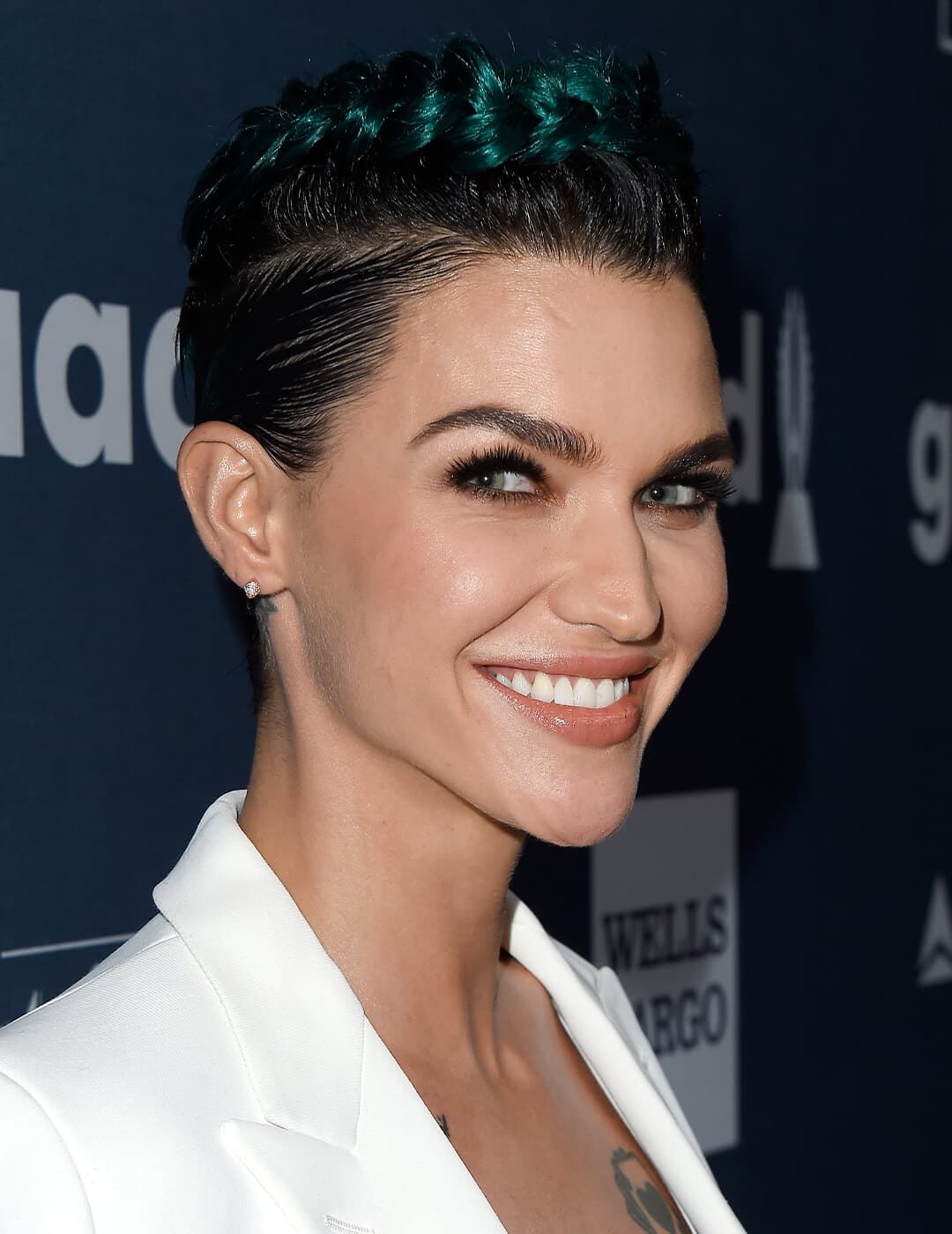 Smiling Ruby Rose rocking an undercut pixie hairstyle and smoky eye makeup look