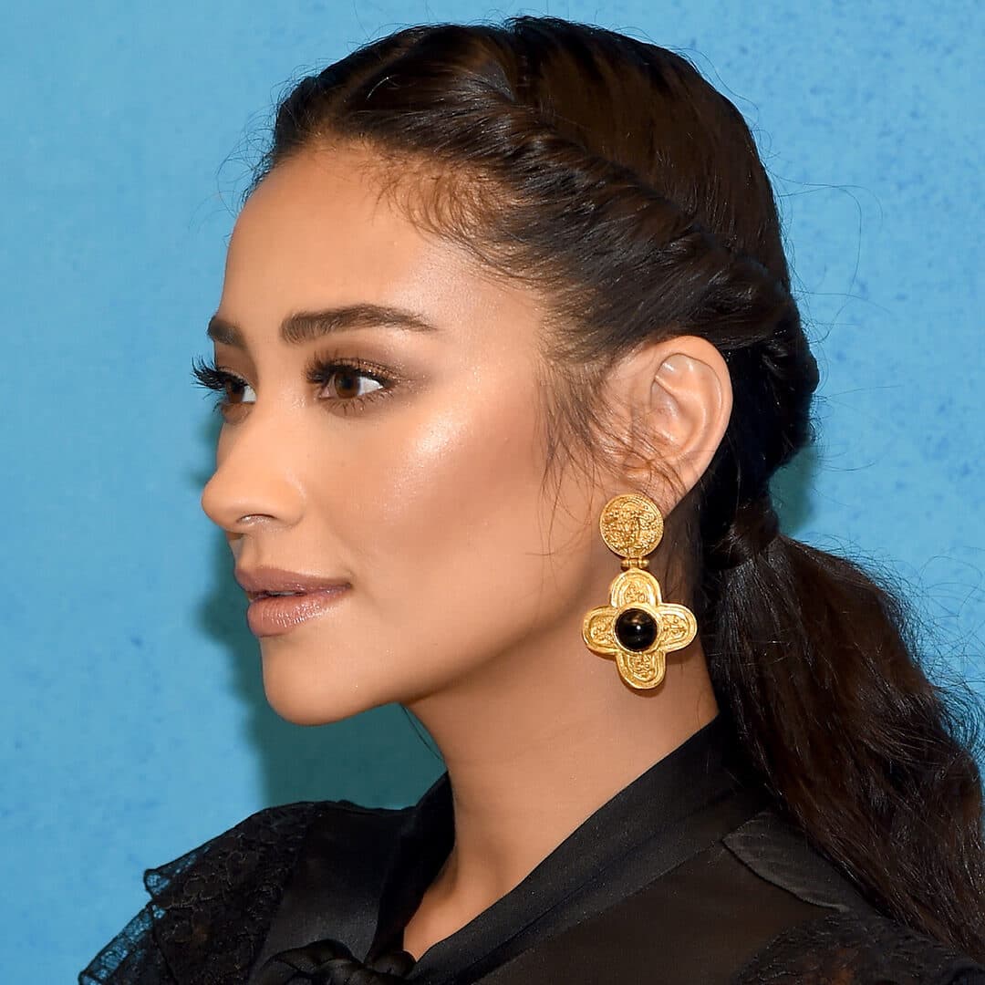 A photo of Shay Mitchell with a twisted back ponytail