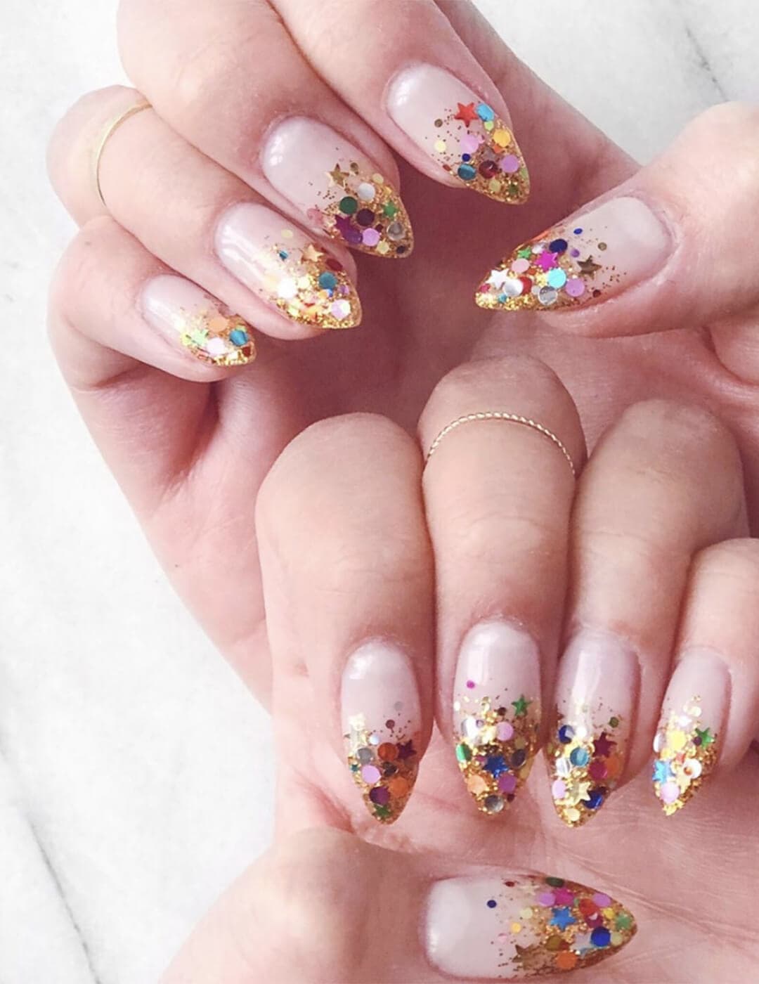Close-up of a woman's hands with glitter ombré nail art