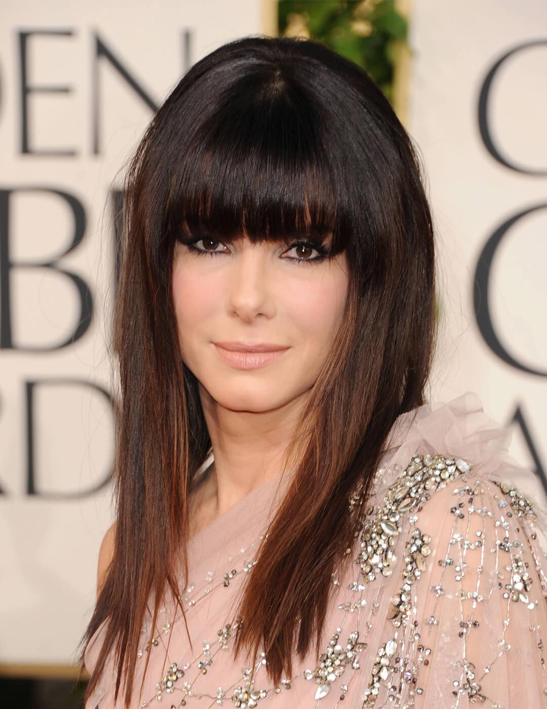 Sandra Bullock rocking full bangs and sequined nude dress at the red carpet