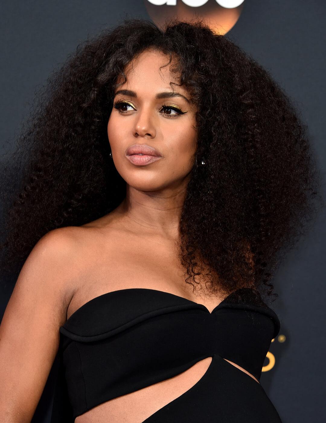 A photo of Kerry Washington with flowing curls wearing a black dress