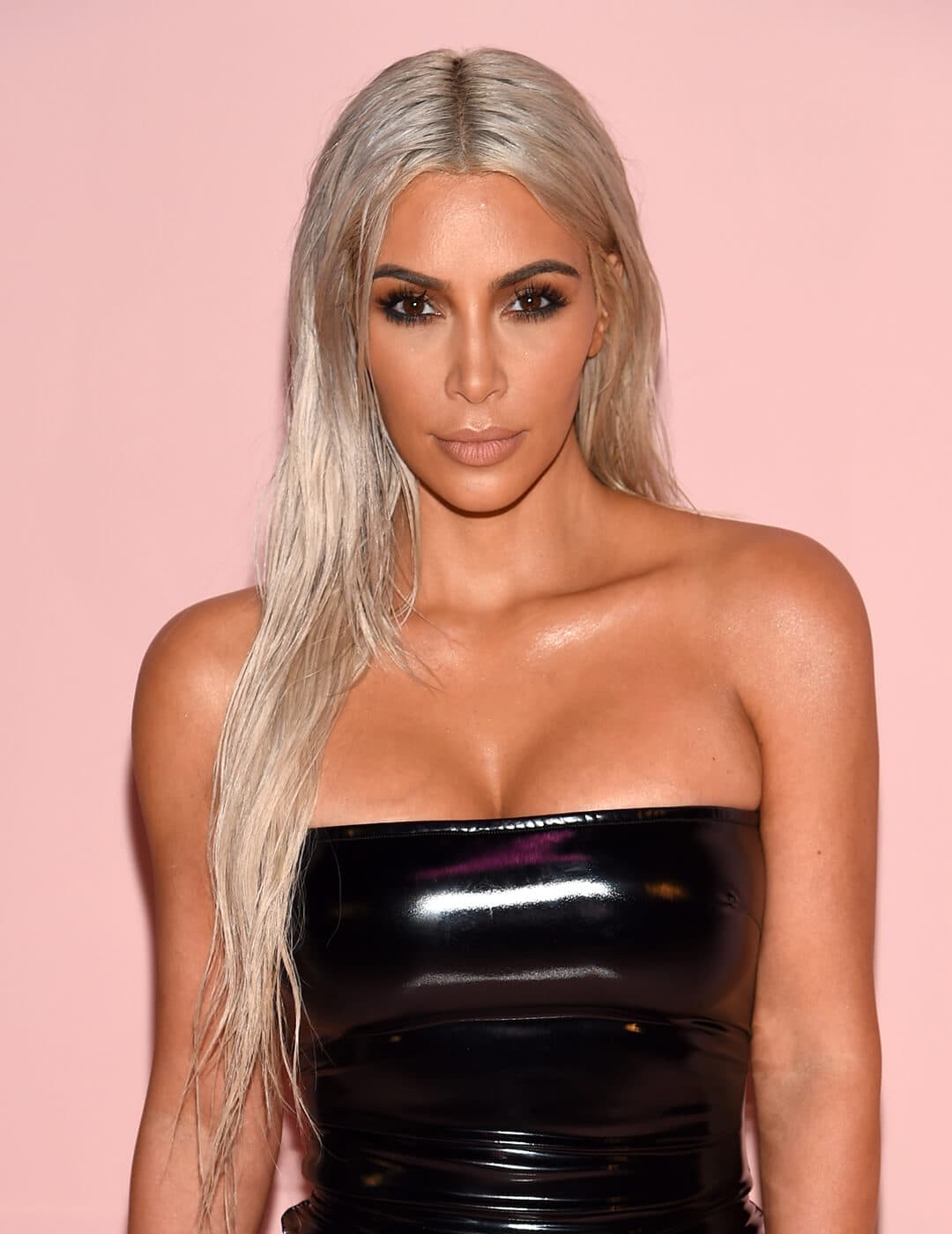 A photo of Kim Kardashian being sexy with a silver blonde hair color