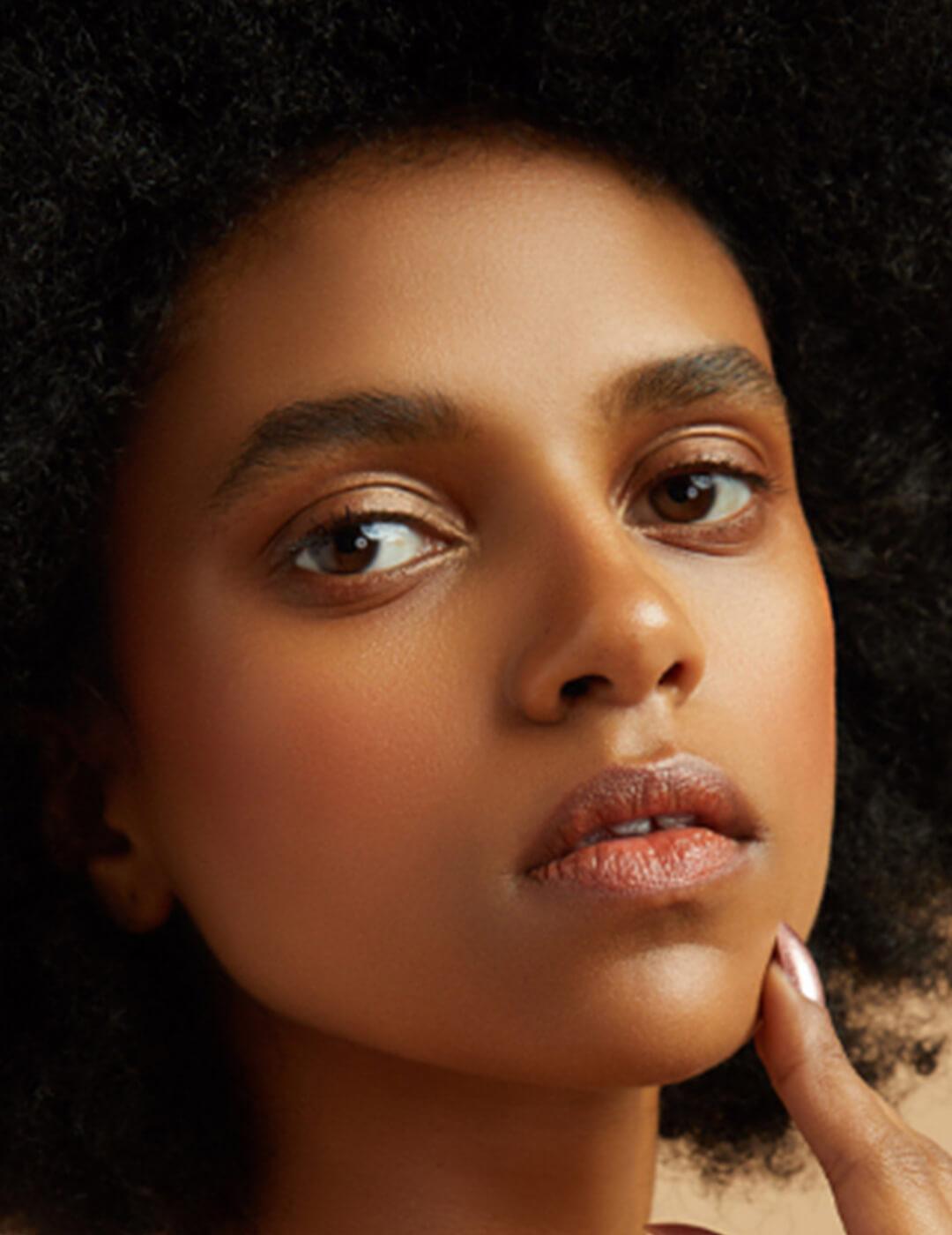 Close-up of a model rocking a glowy natural makeup look