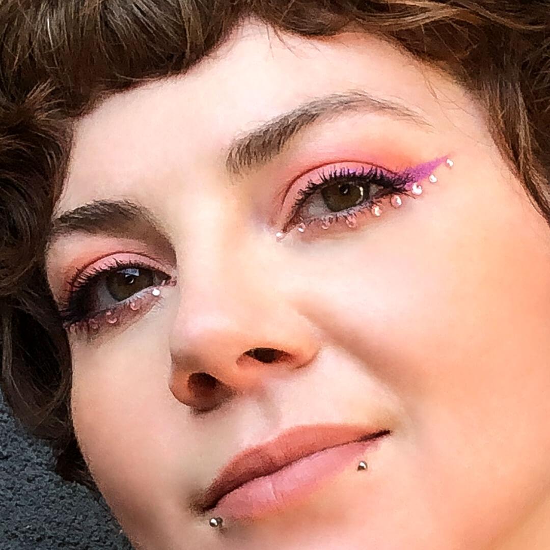 Close-up image of Kirsten Colemen's pink eyeshadow and rhinestones makeup look