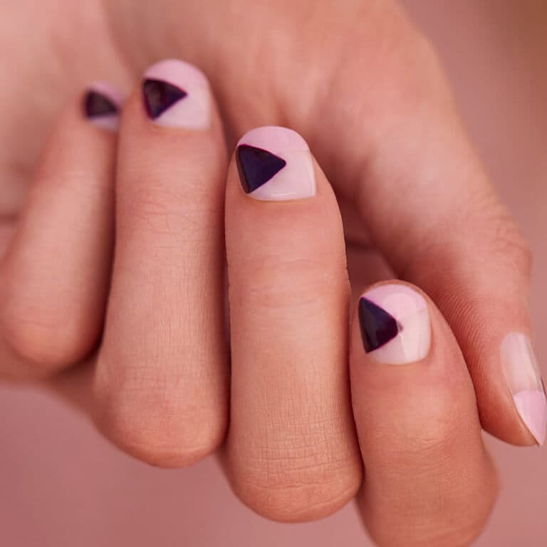 An image of a light pink and dark purple geometric nail art manicure