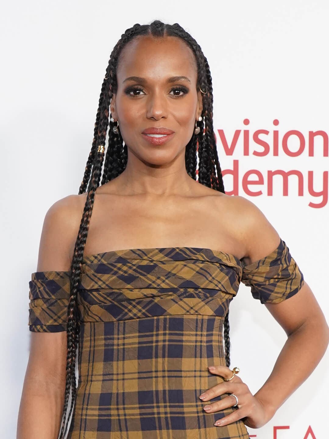 Kerry Washington in a plaid dress rocking a long goddess braid hairstyle embellished with charms
