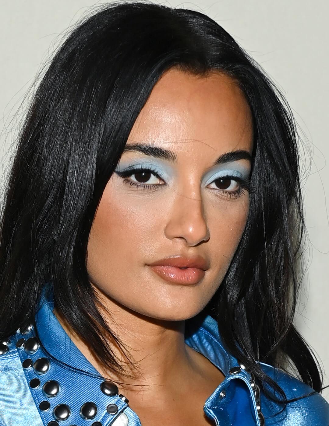 Close-up of Amina Muaddi rocking a frosty blue eyeshadow makeup look