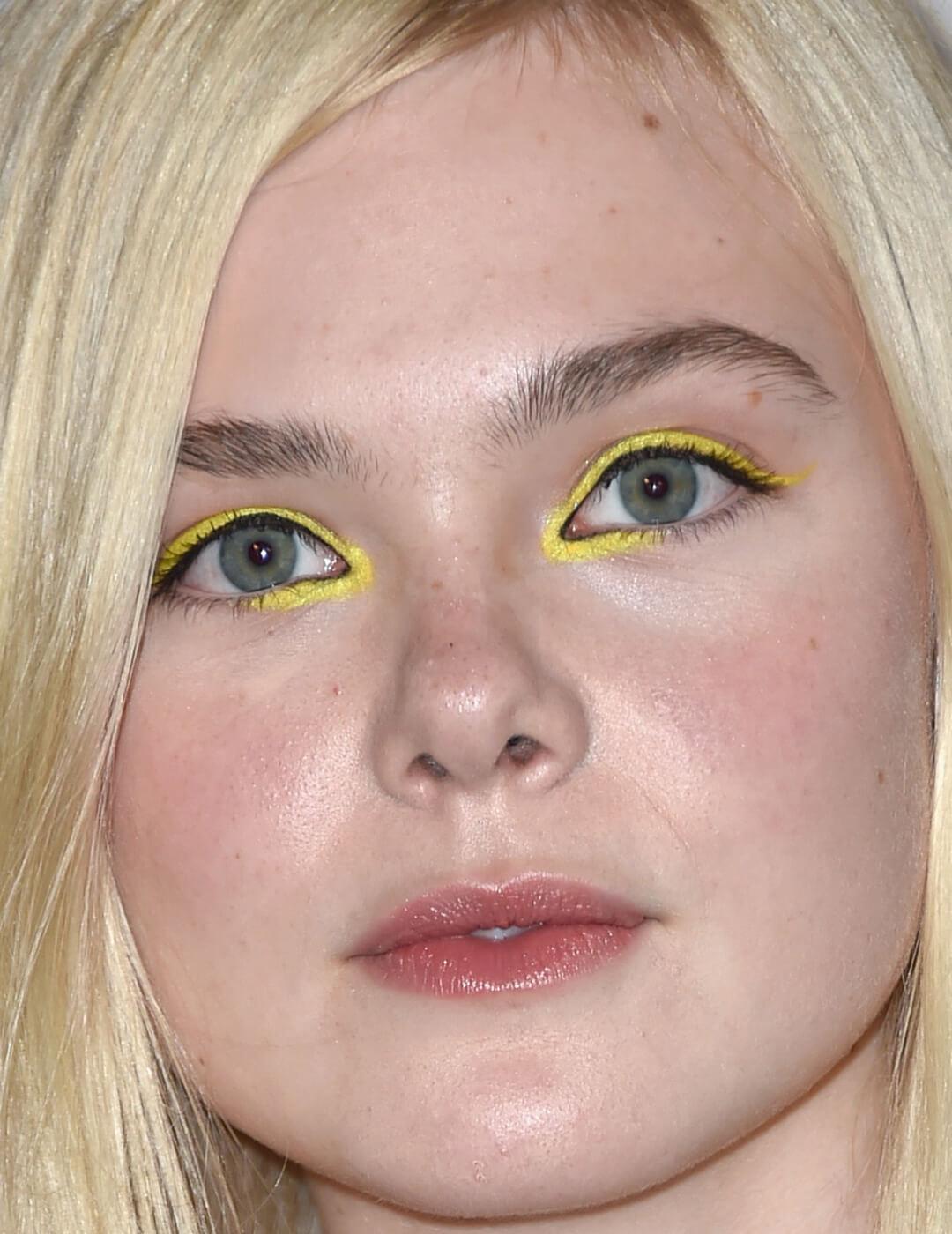 Close-up image of Elle Fanning rocking a yellow eyeliner look