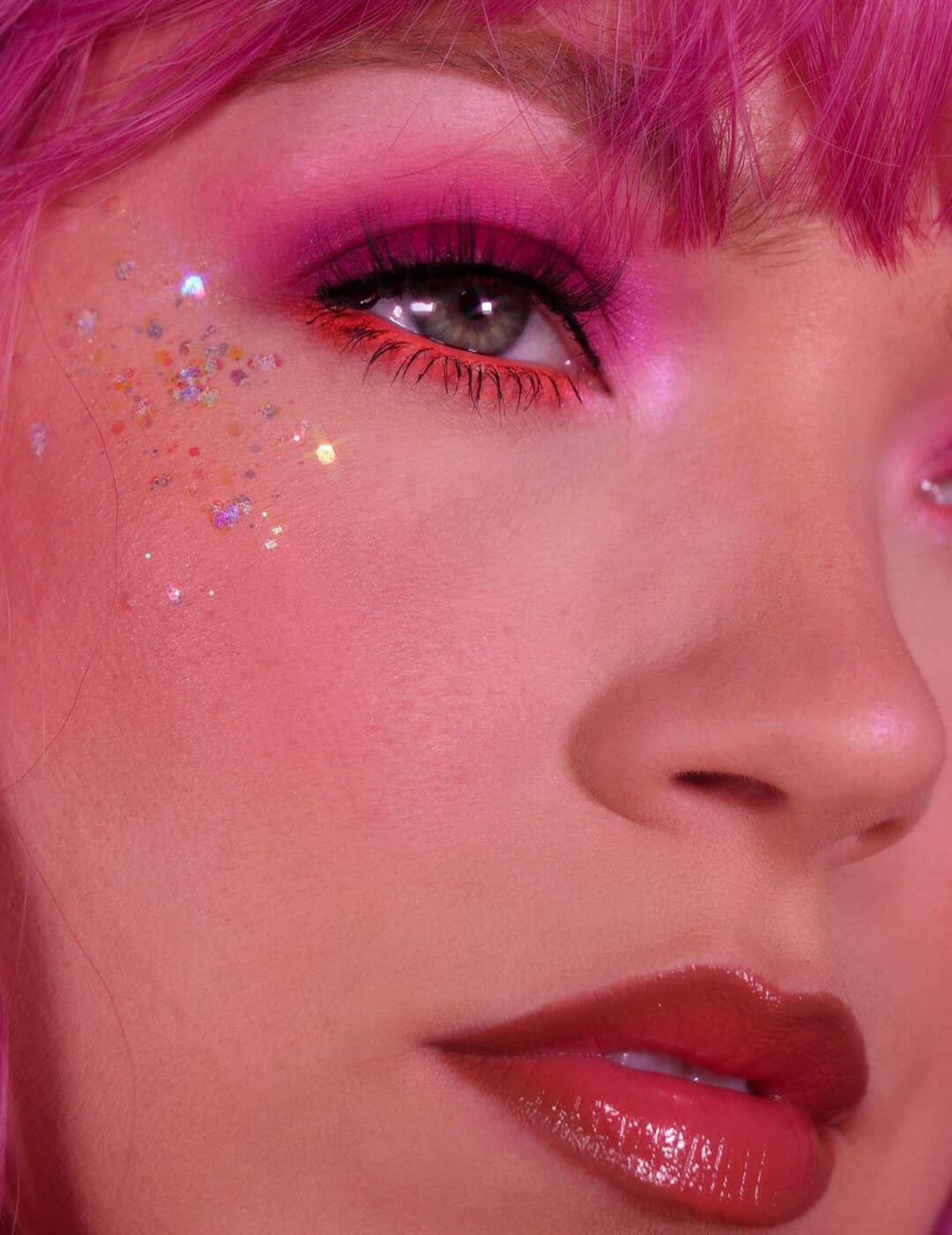 Close-up of a young woman's glittery pink and orange eyeshadow makeup look
