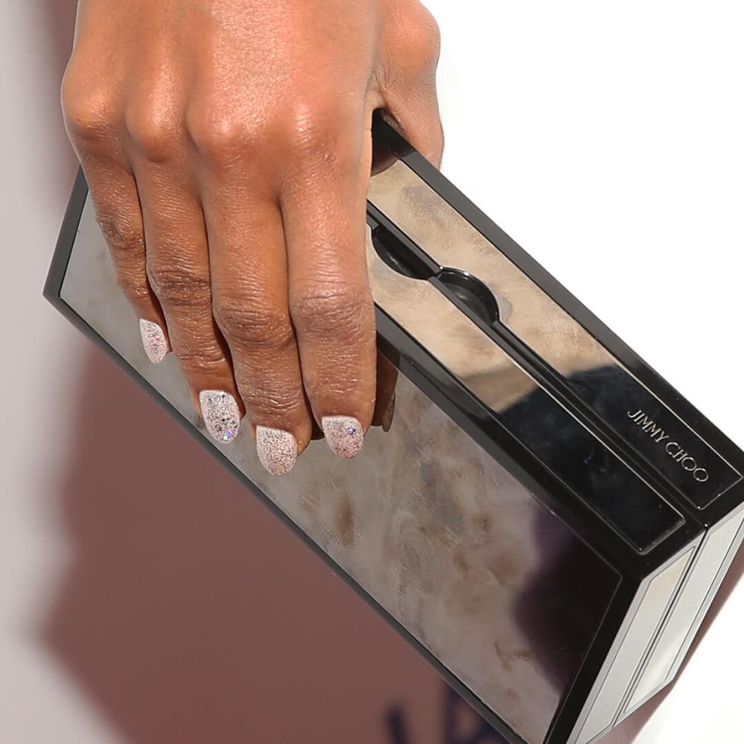 Close-up of Kerry Washington's hands with glitter nails holding her purse