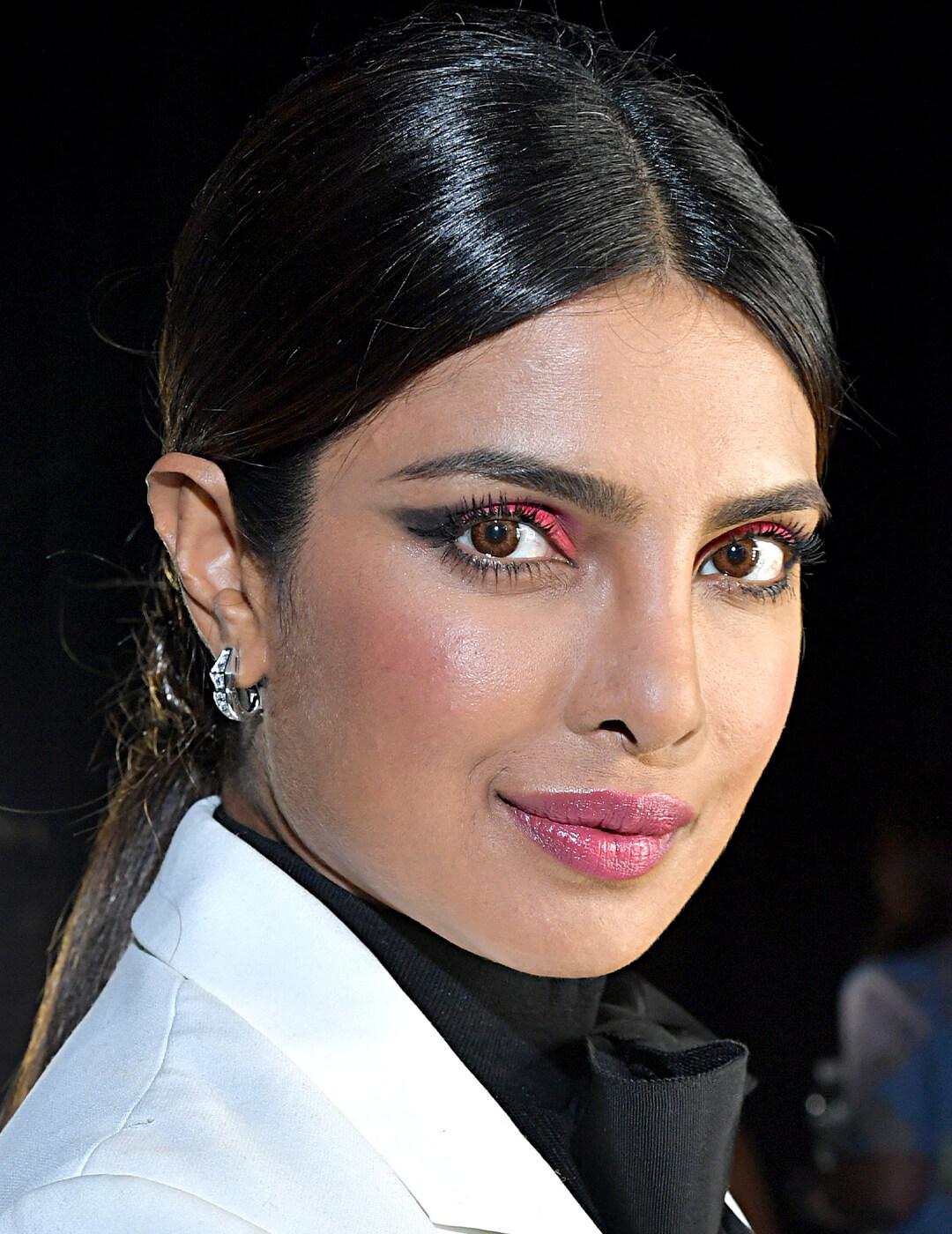 Priyanka Chopra rocking a bold red eyeshadow makeup look paired with glossy pink lips
