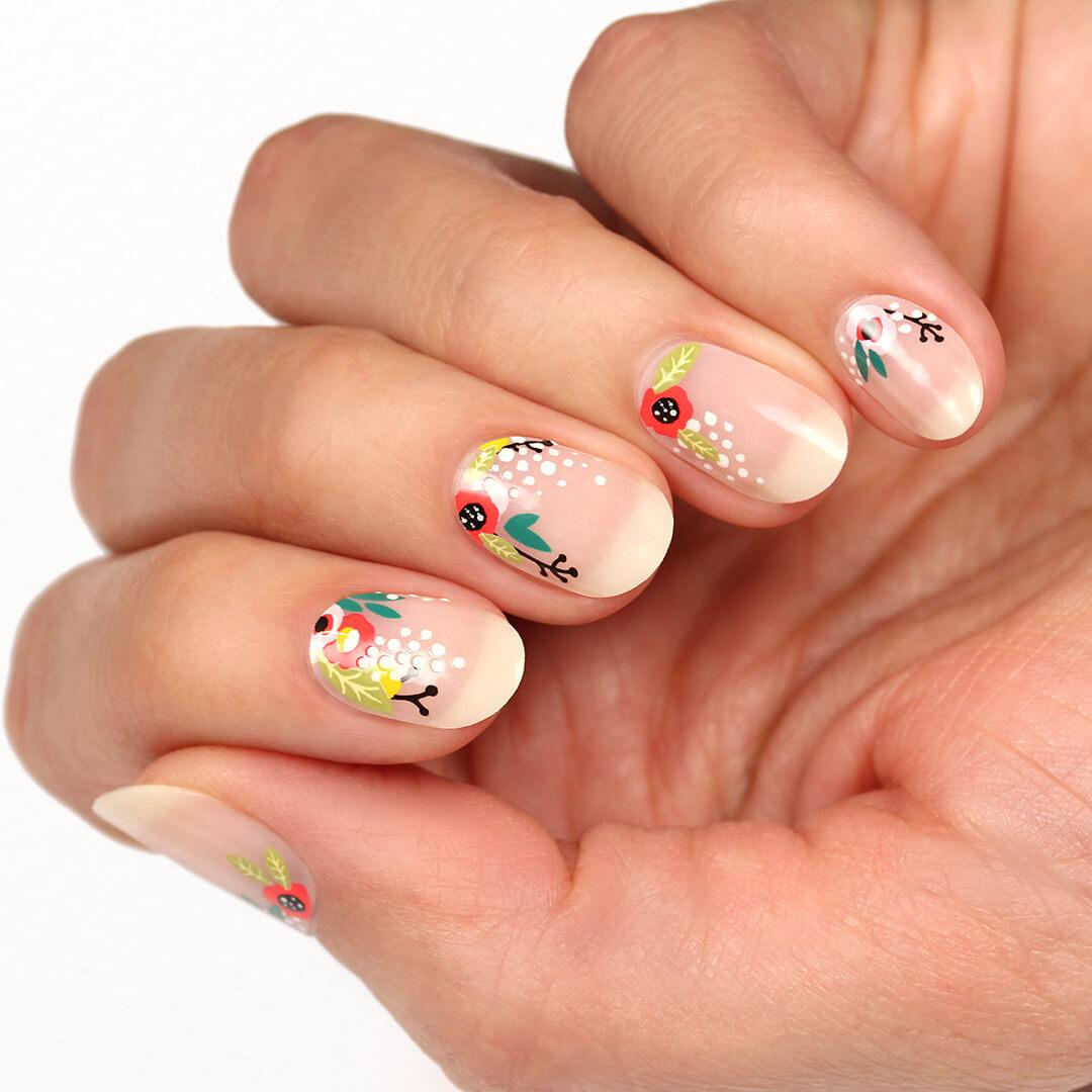 Close-up of a model's hands with MANIME Stick On Gel Mani in Floral Cuticles
