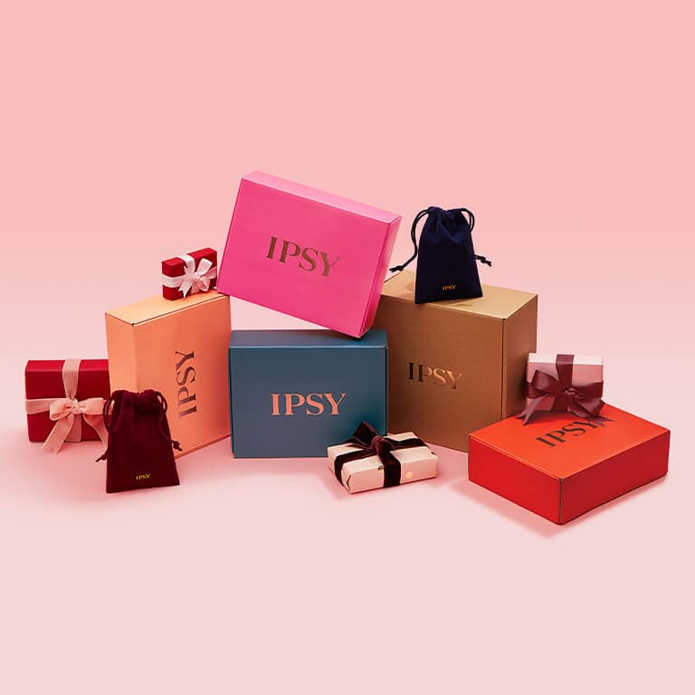 An image of boxes, gift boxes, and pouches of different sizes, shapes, and colors all with gold IPSY logos