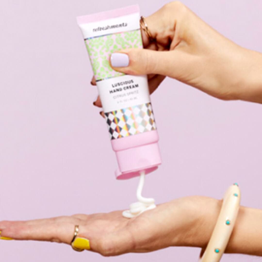 An image of hand-held Refreshments product of IPSY on a pink background