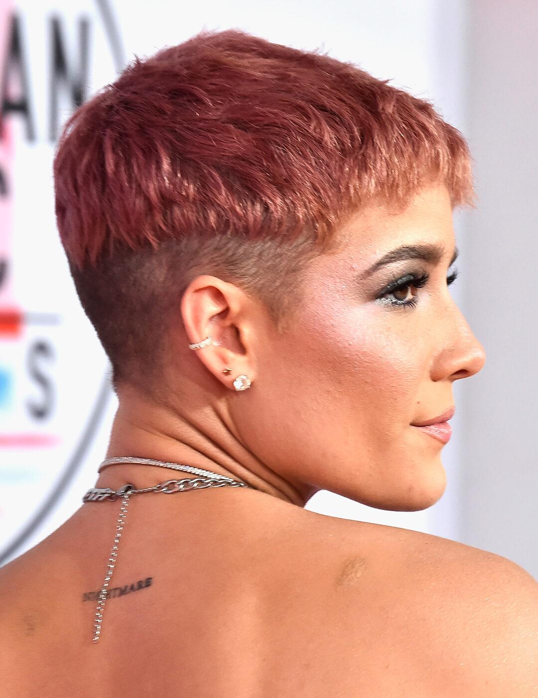 Side profile of Halsey rocking a rose gold blunt pixie undercut hairstyle on the red carpet