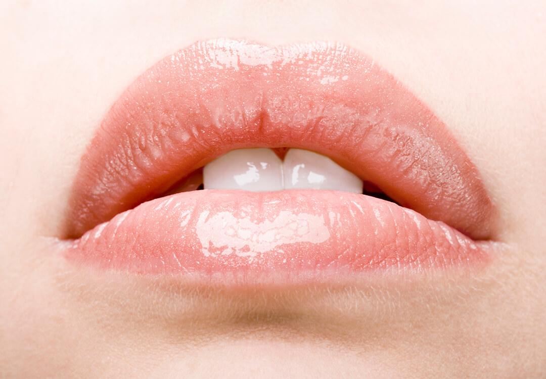 Close-up of a girl's glossy lips
