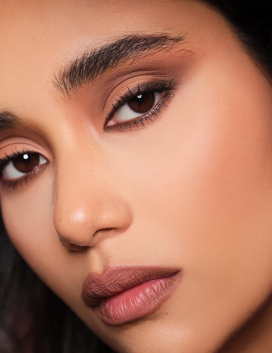 A closeup photo of a model's face with a matte look