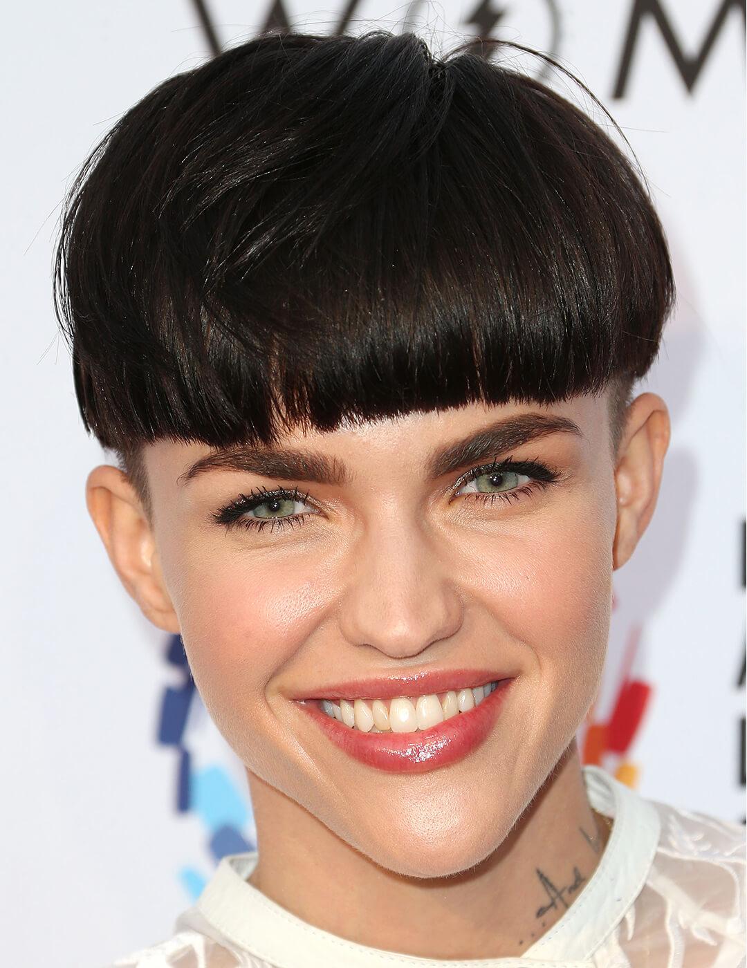 Ruby Rose smiling and rocking a blunt bowl undercut hairstyle on the red carpet