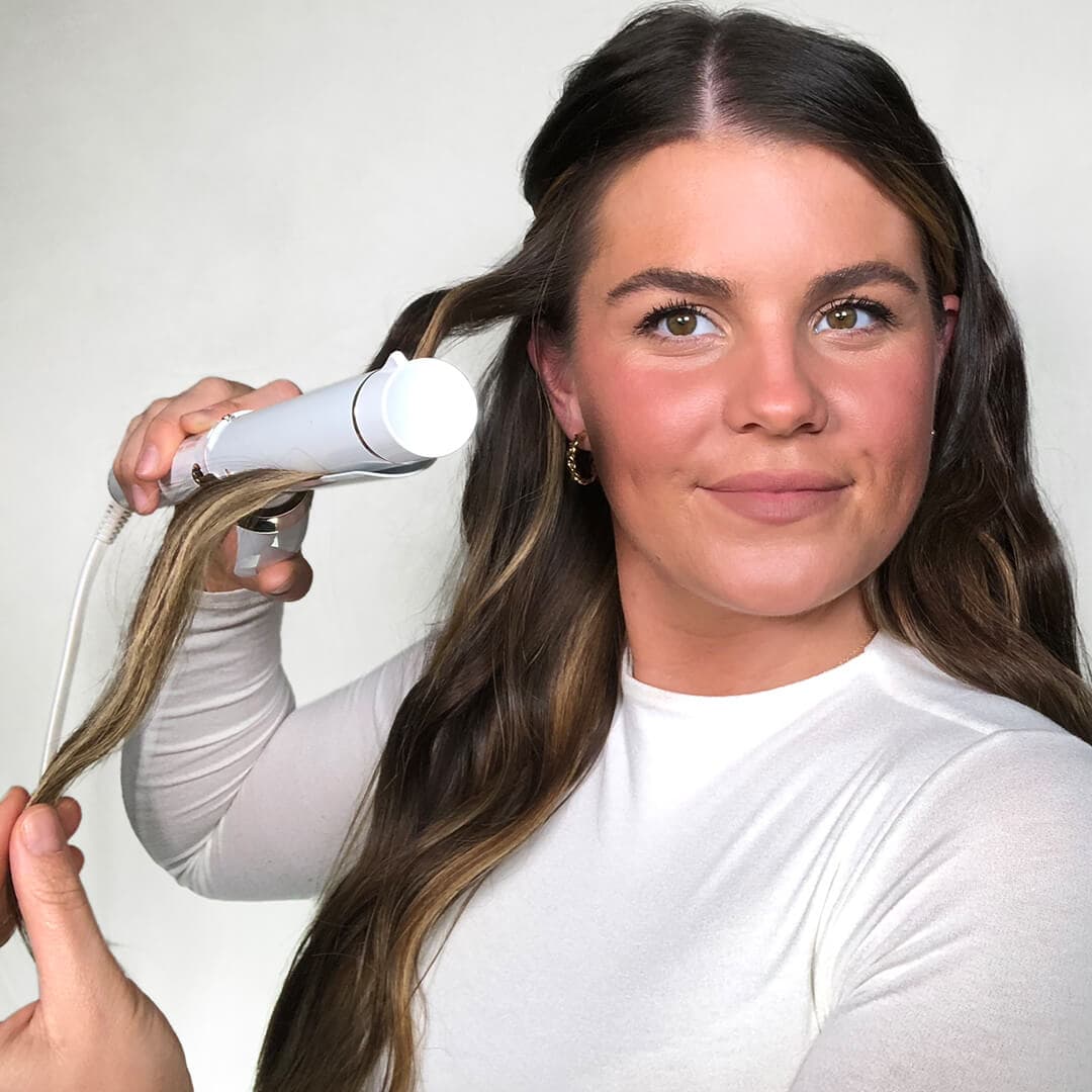 Image of Melissa Hurkman styling her hair with a curling iron