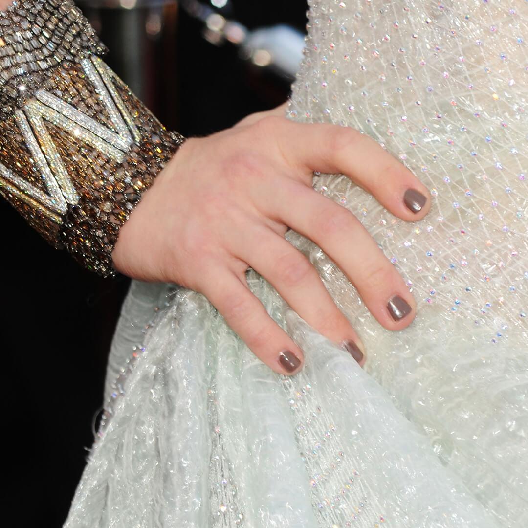 Close-up of Amanda Seyfried's grey nails on her white sequined dress