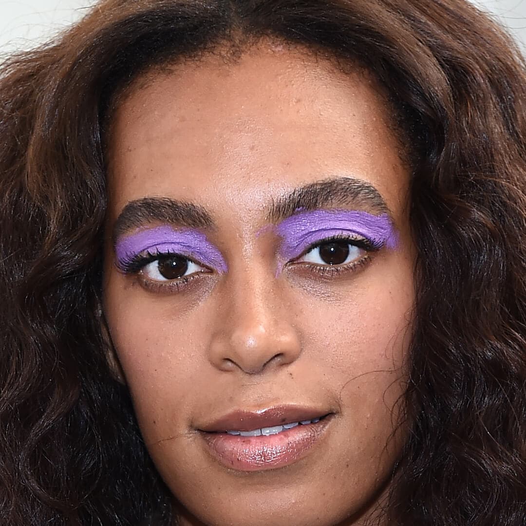 Close-up image of Solange Knowles rocking a bold purple eye makeup look