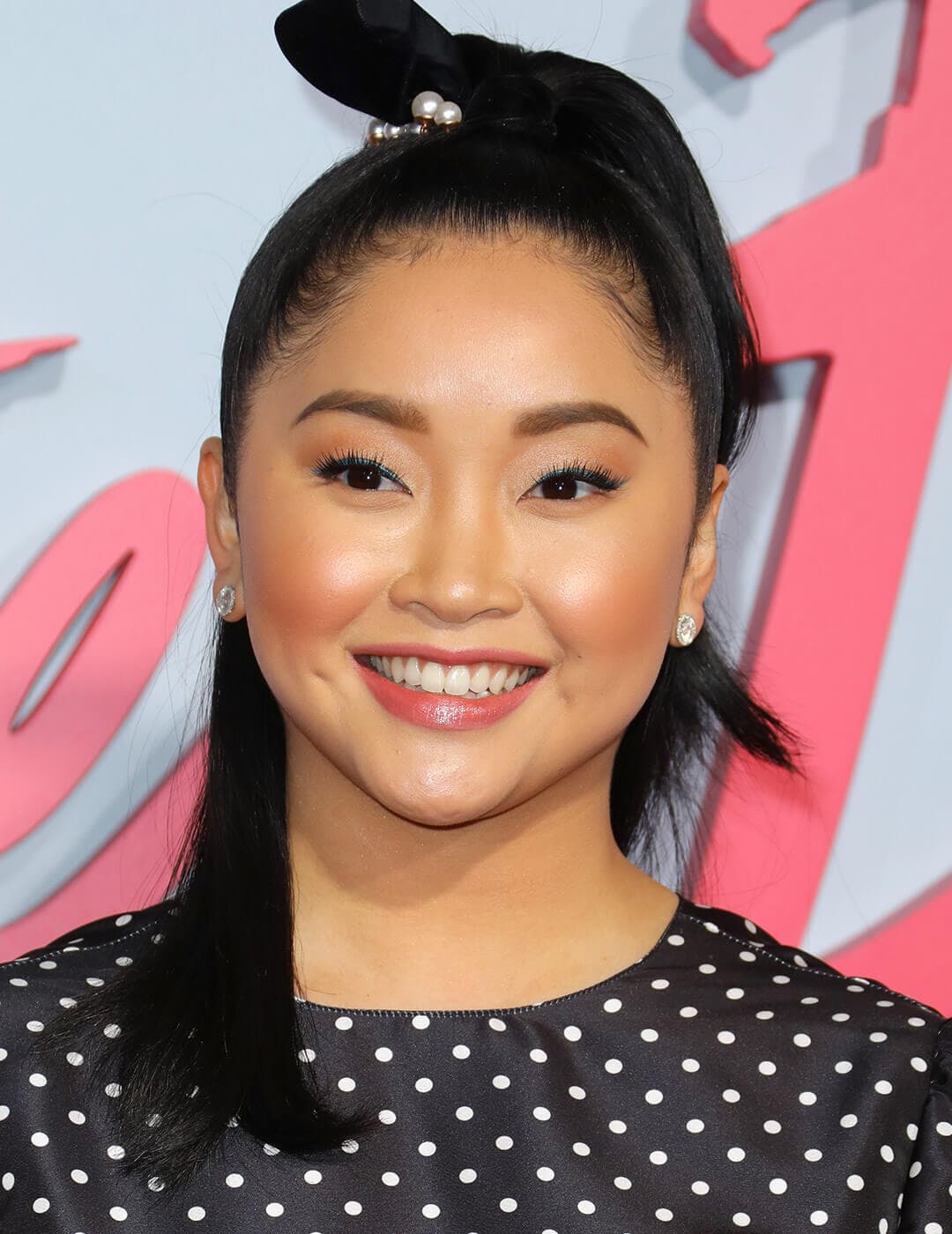 A photo of Lana Condor wearing a black hairband with pearls