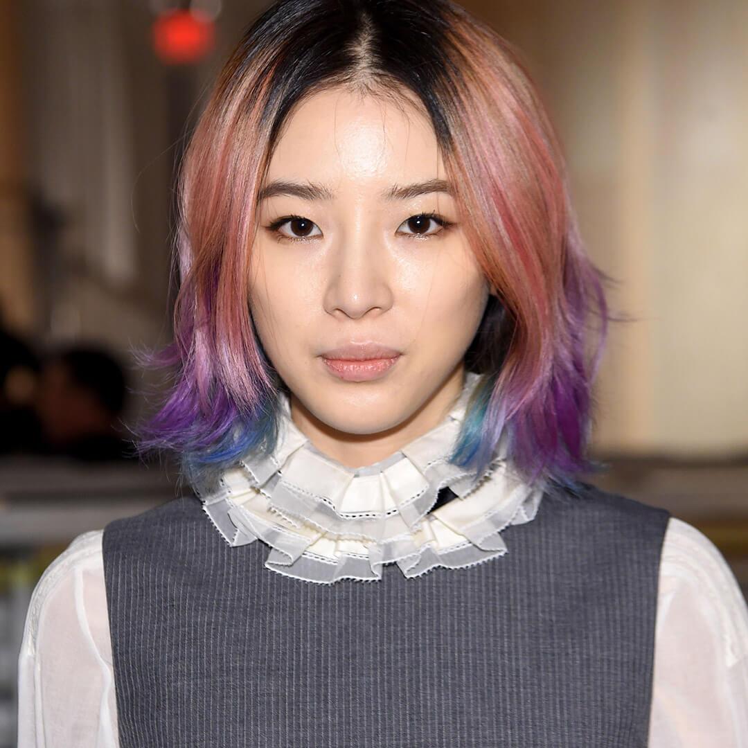 A photo of Irene Kim with strawberry blonde hair and blue tips