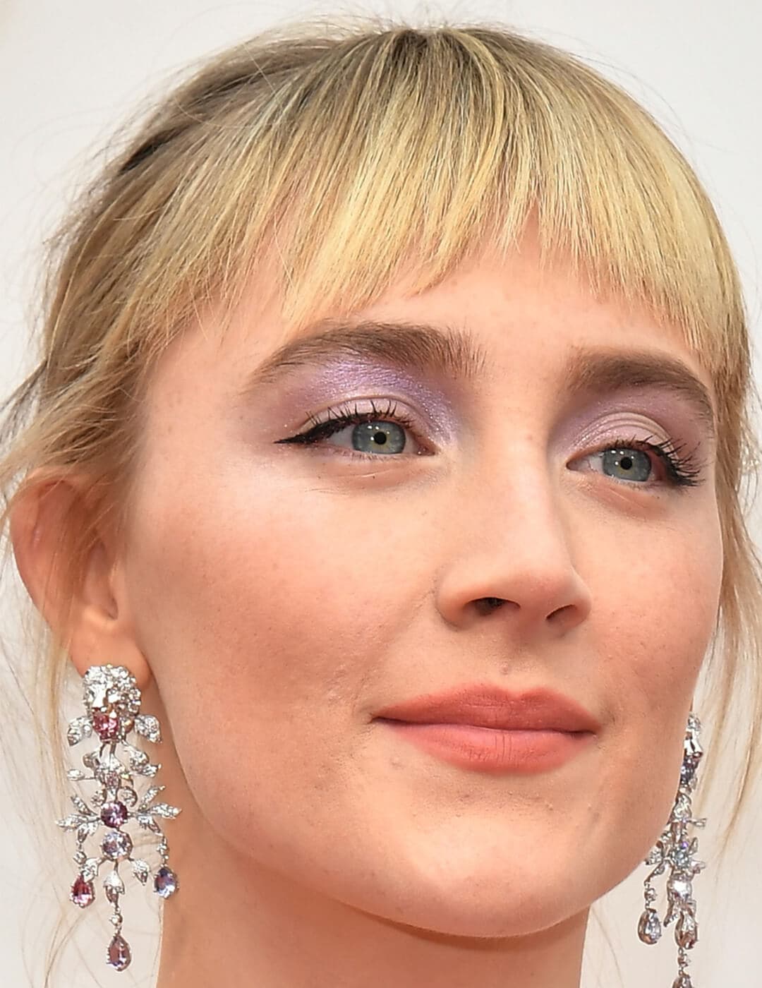 A photo of Saoirse Ronan showing her combined blue and purple eyeshadow on a white background