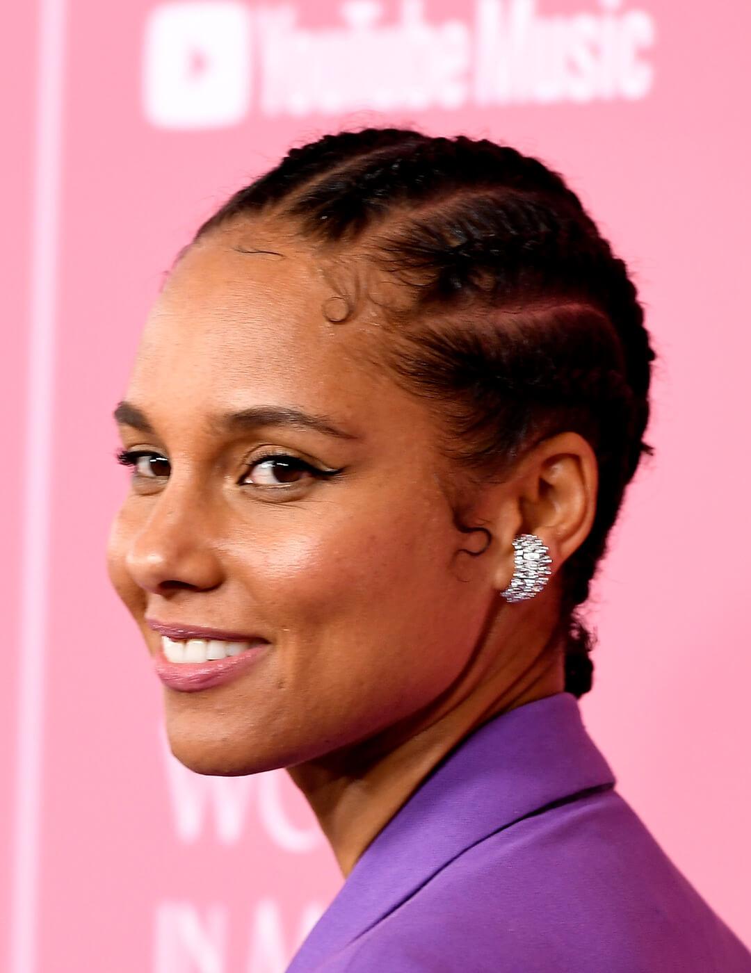 Alicia Keys in a purple suit rocking a cornrows braided hairstyle