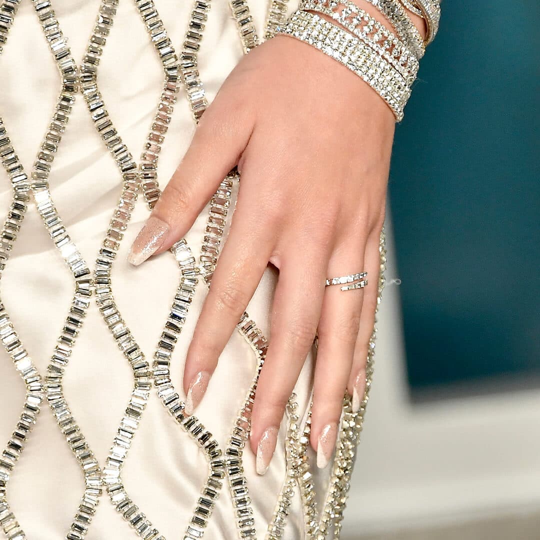 Close-up of Hailee Steinfeld's glass French mani against bejewelled dress