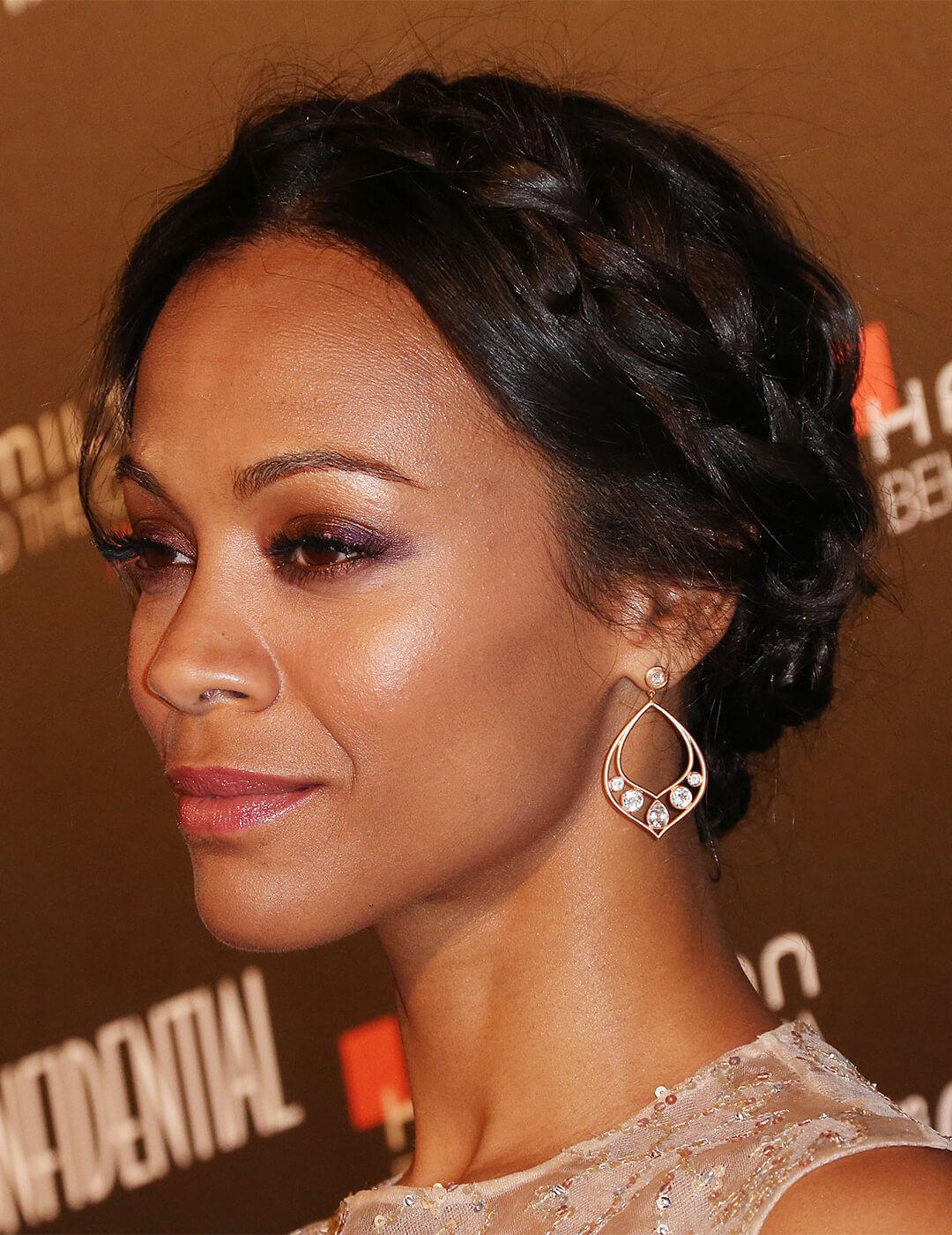 Close-up of Zoe Saldana rocking a smoky eyeshadow makeup look and crown braided hairstyle