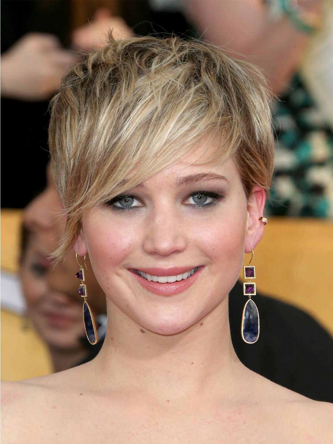 Jennifer Lawrence rocking a layered pixie cut hairstyle with side-swept bangs