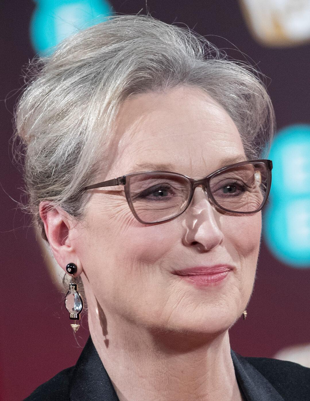 A photo of Meryl Streep with a gradual gray updo hairstyle
