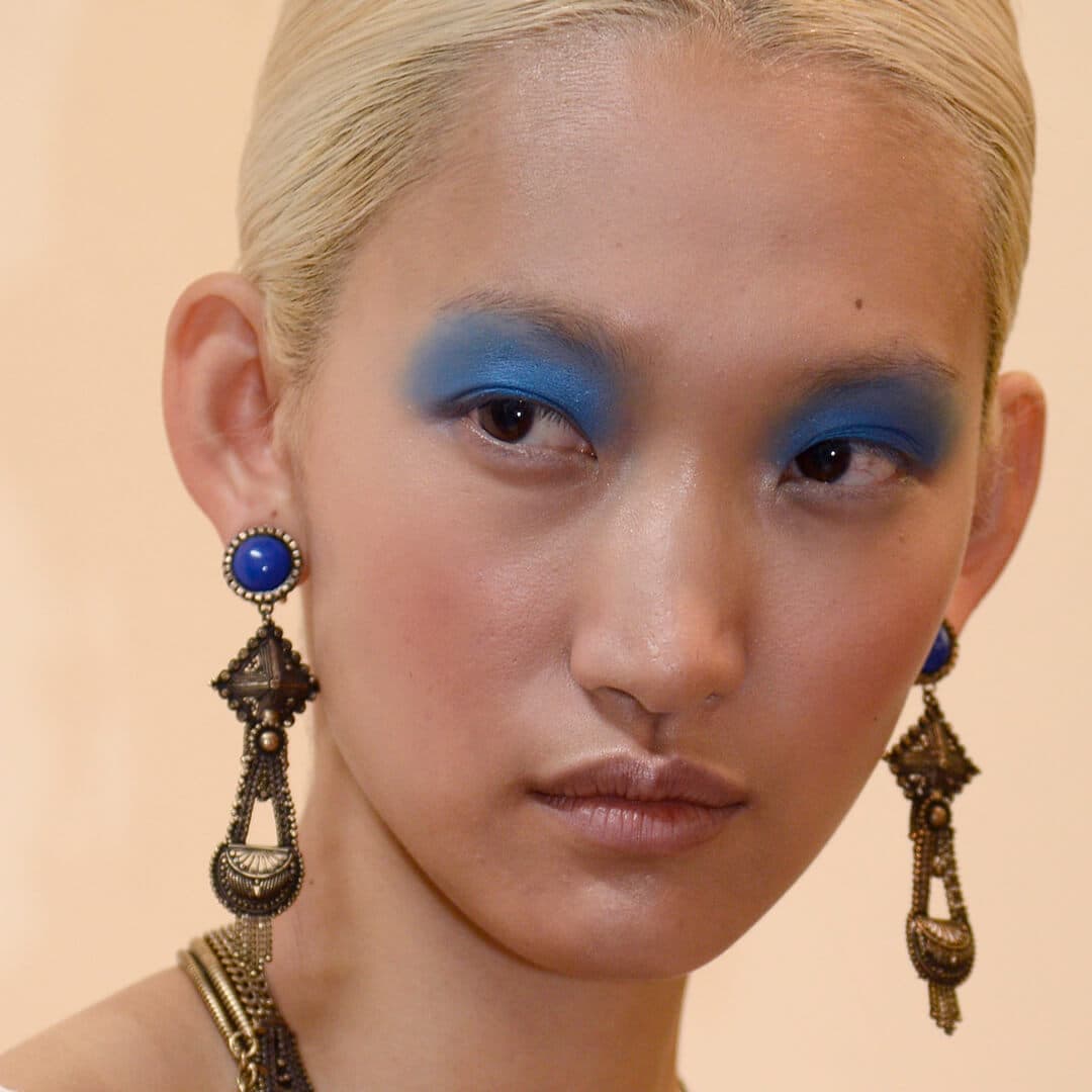 Close-up image of a model rocking a matte blue eyeshadow look