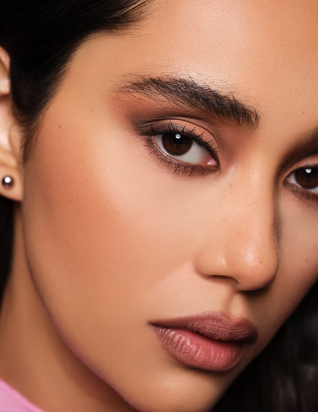 A closeup photo of a model's face with a matte look