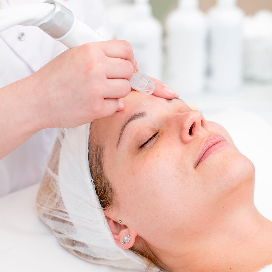 Image of a woman getting a microdermabrasion facial treatment