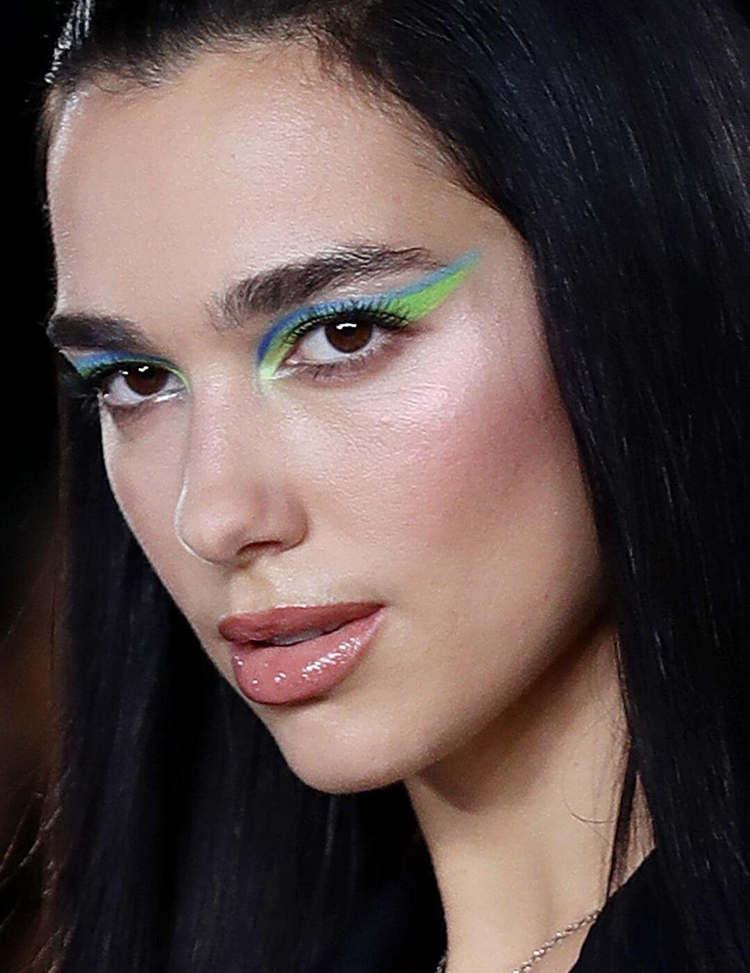 Close-up of Dua Lipa rocking a blue and green eyeliner makeup look