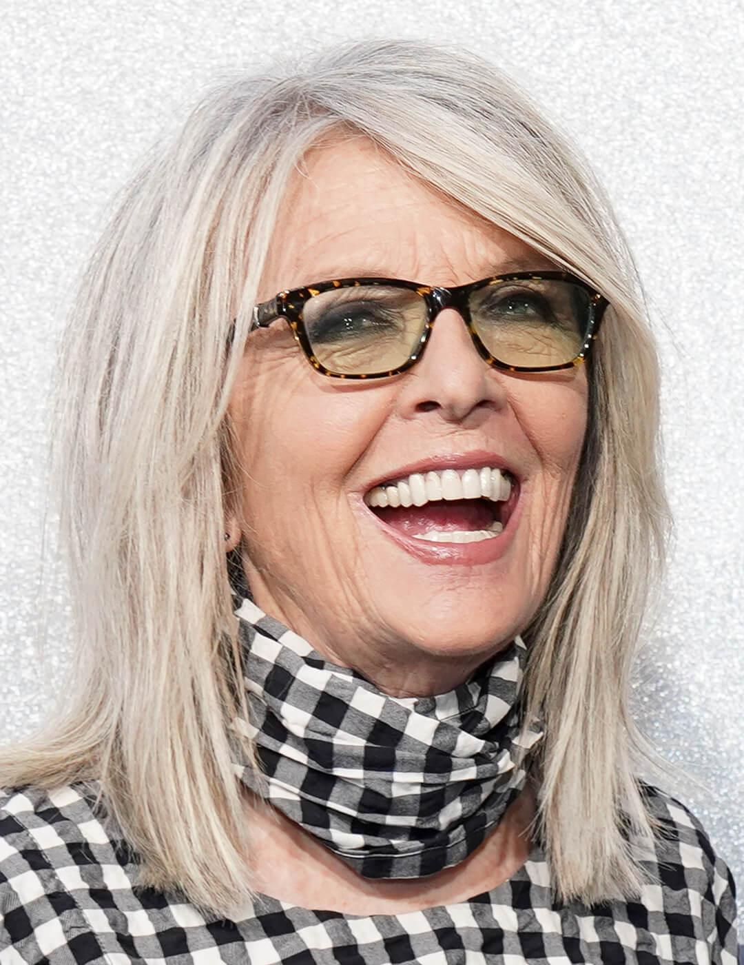 A photo of Diane Keaton wearing glasses with a multi-dimensional gray layers hairstyle