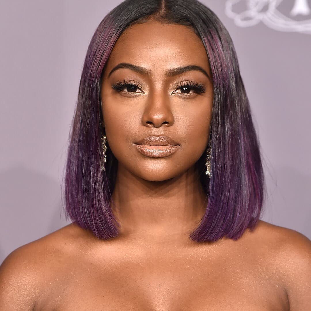 A photo of Justine Skye with purple hair