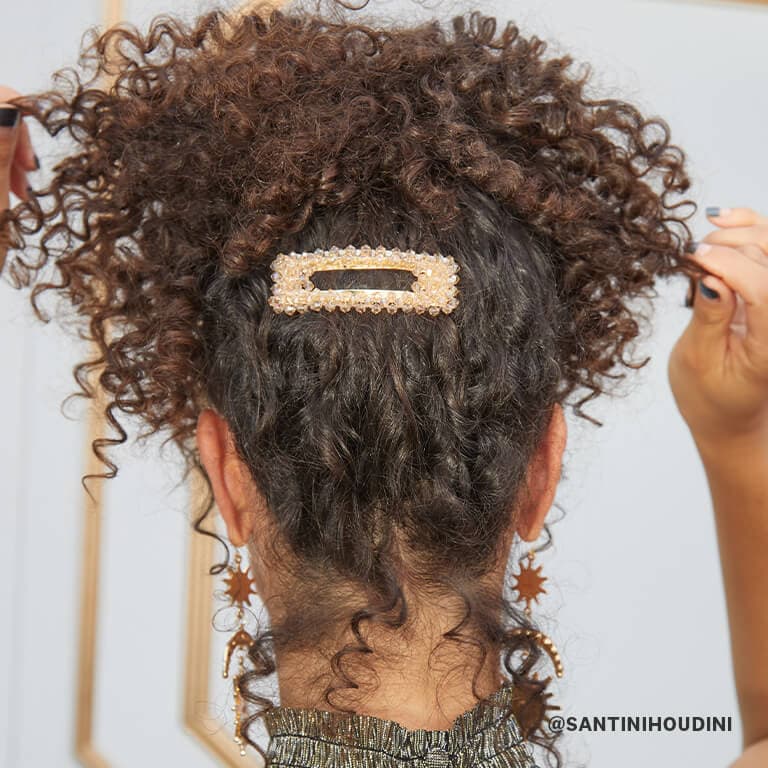 Christina Santini wearing a messy high pony tail with a big studded hair clip
