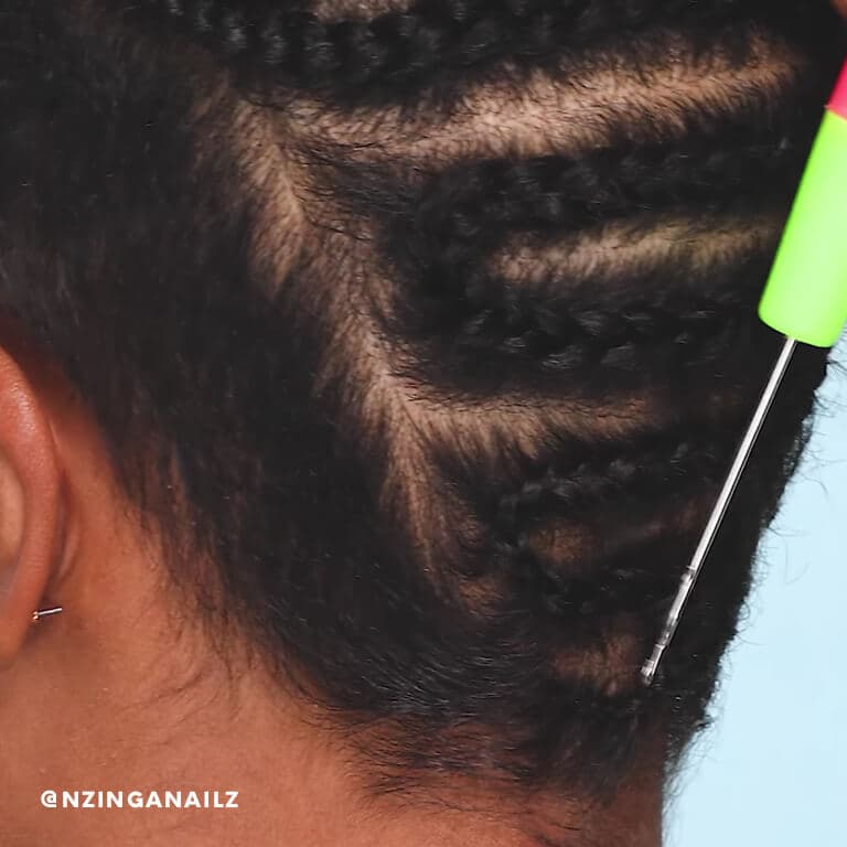 A hairstylist shows how to loop a hair extension into your cornrows using a crochet hook. 