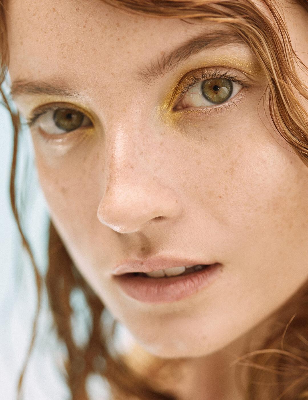Close-up of a model rocking a gold eyeshadow makeup look
