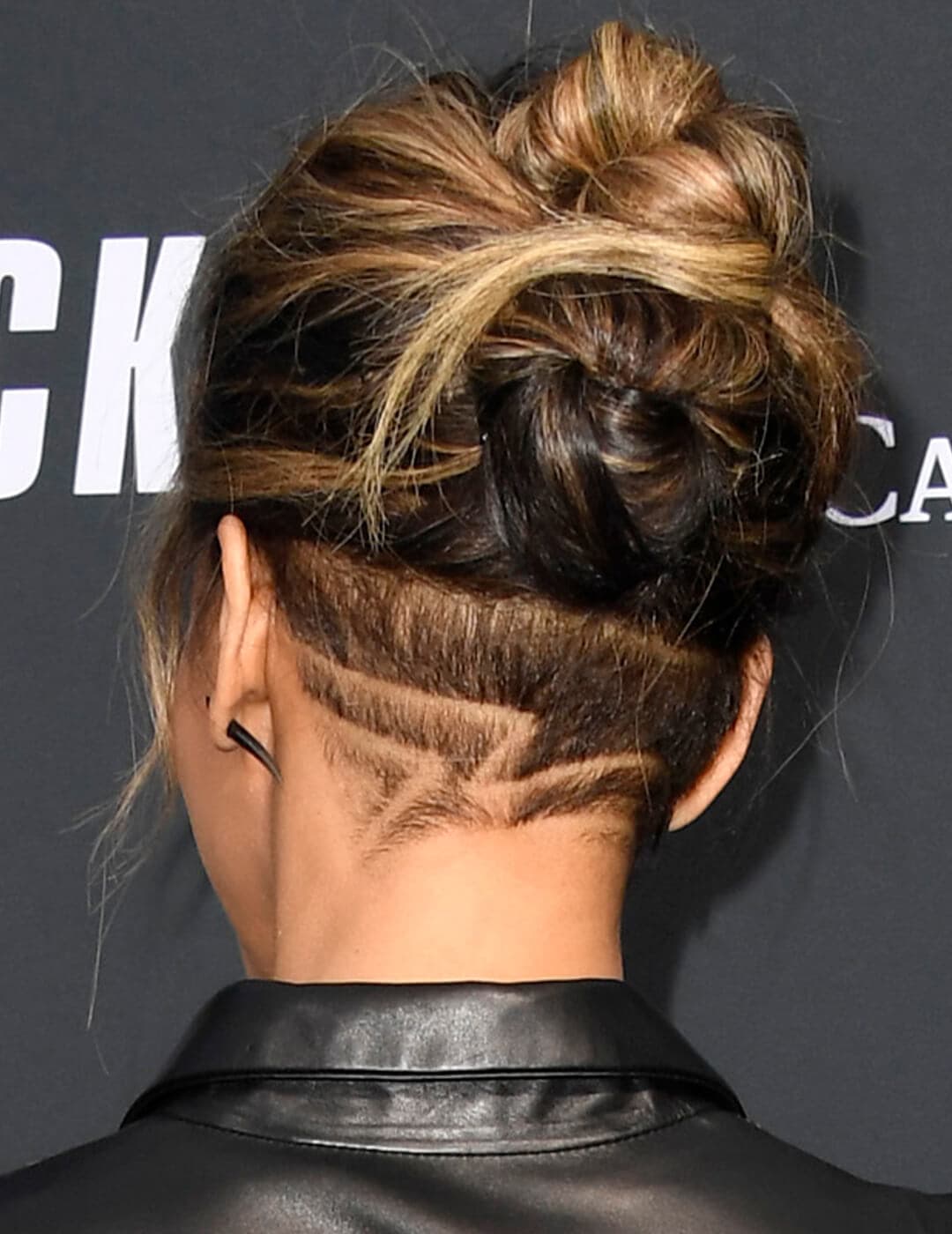 Back view of Halle Berry's updo undercut hairstyle with intricate details