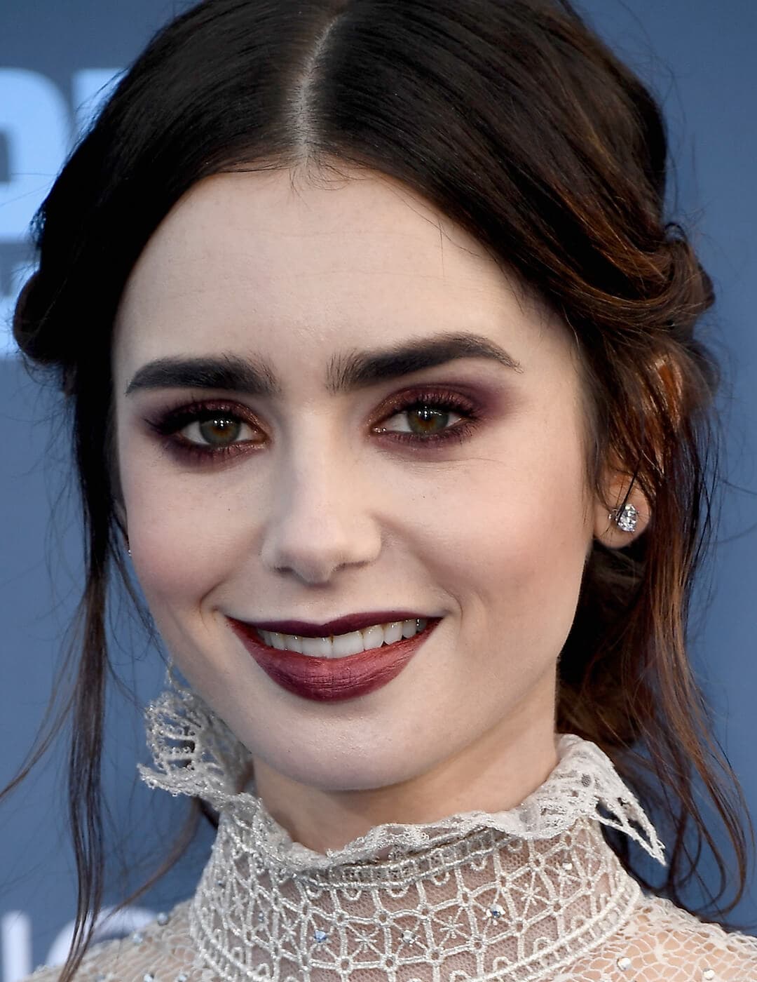 Close-up of Lily Collins rocking a very deep burgundy eyeshadow look