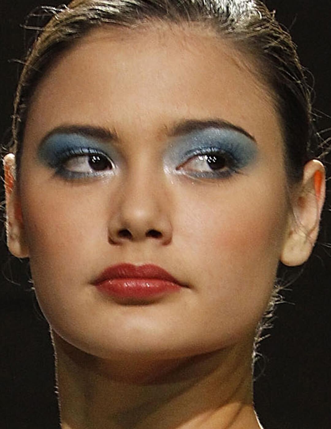 Model rocking a 90's blue eye makeup look