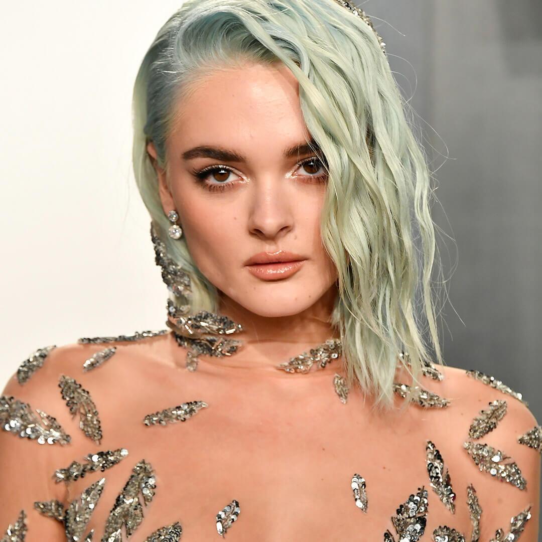 A photo of Charlotte Lawrence and her light green hair with waves