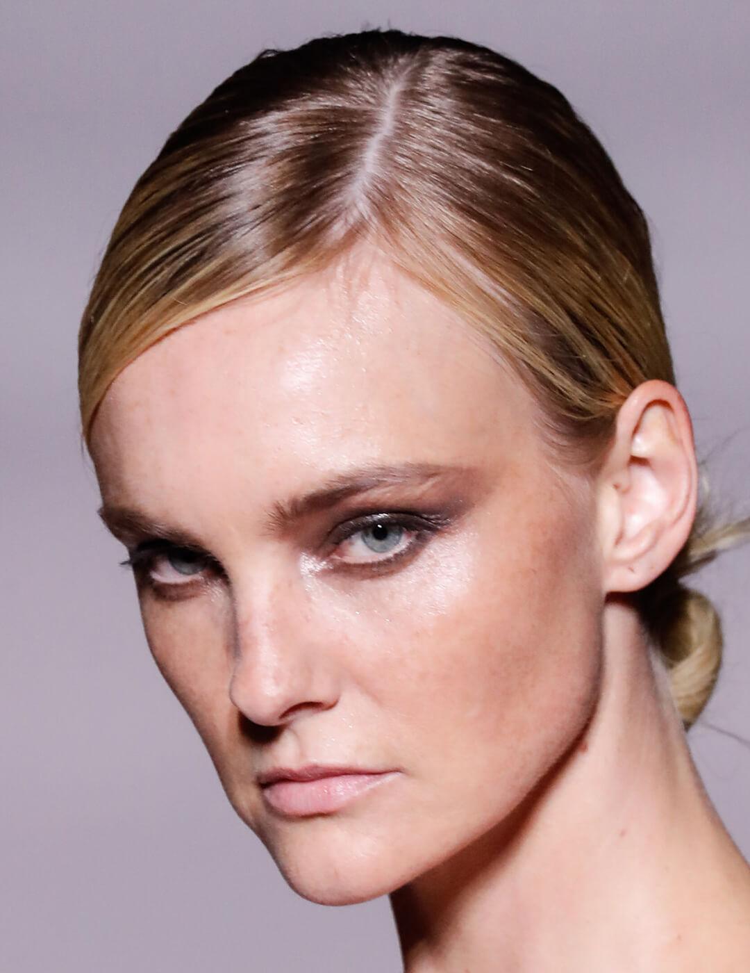 A closeup photo of  Caroline Trentini with her hair tied into a bun 
