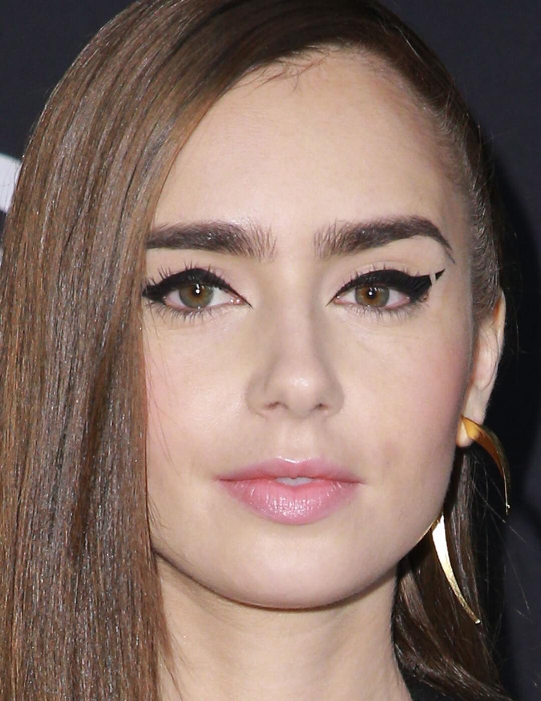 Close-up of Lily Collins with a bold, negative space eyeliner makeup look